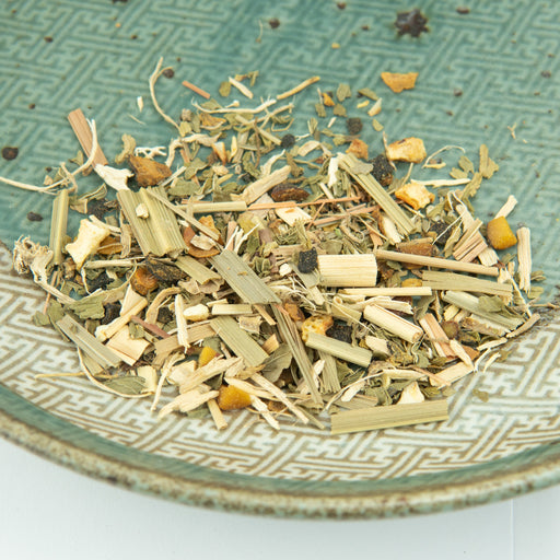 Herbal tea mix on a textured ceramic plate