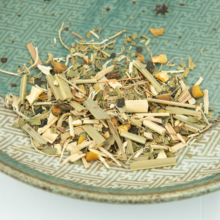 Herbal tea mix on a textured ceramic plate