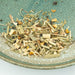 Herbal tea mix on a textured ceramic plate