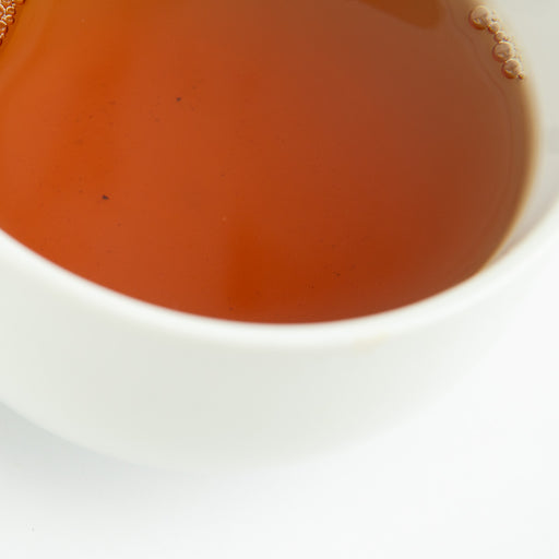 Close-up of a white bowl with tea.