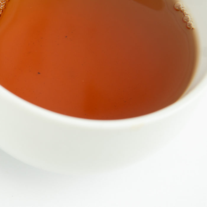 Close-up of a white bowl with tea.
