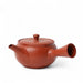 Red clay teapot on a white background